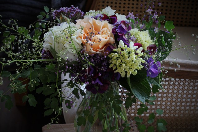 vase of Just Joey rose with hydrangeas thalictrum and sweet peas and statice